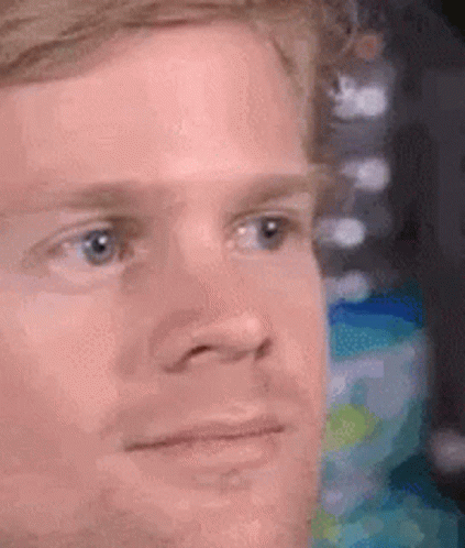 A Close Up Of A Man 'S Face With A Serious Expression On His Face . GIF