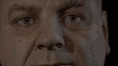 A Close Up Of A Man 'S Face With A Serious Look On His Face GIF