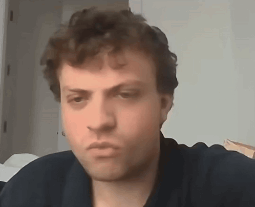 A Close Up Of A Man 'S Face With A Serious Look On His Face . GIF