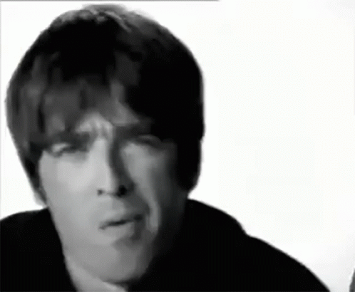 a close up of a man 's face with a serious look on his face in a black and white photo .
