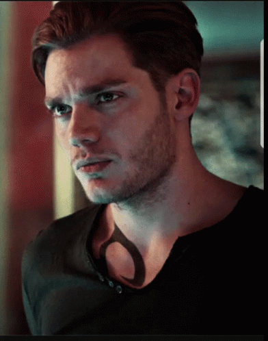 A Close Up Of A Man 'S Face With A Shadow On His Chest GIF