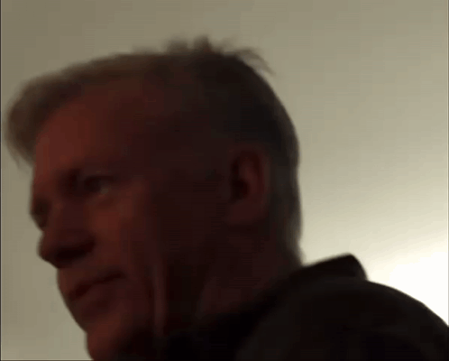 A Close Up Of A Man 'S Face With A Shadow On His Face GIF