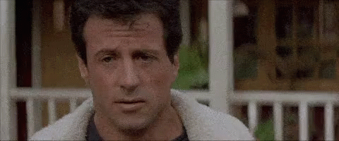 A Close Up Of A Man 'S Face With A Sheep 'S Fur Jacket On . GIF