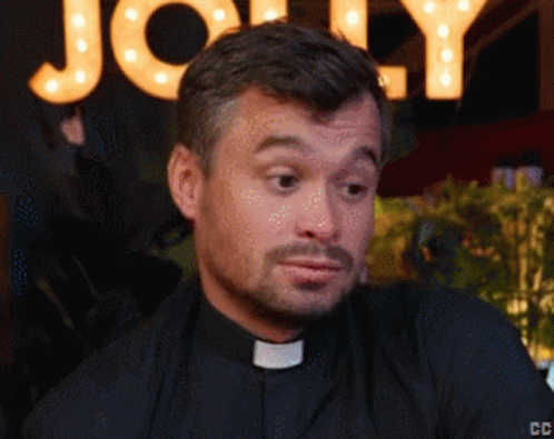 A Close Up Of A Man 'S Face With A Sign Behind Him That Says Jolly GIF