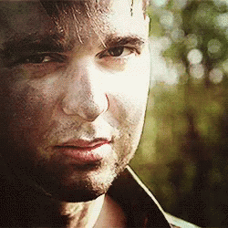 A Close Up Of A Man 'S Face With A Slight Smile On His Face . GIF