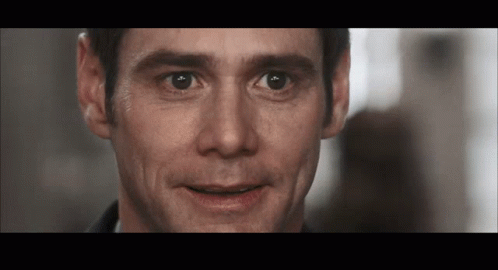 A Close Up Of A Man 'S Face With A Slight Smile On His Face GIF