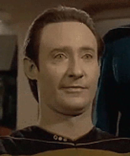 A Close Up Of A Man 'S Face With A Slight Smile On It . GIF