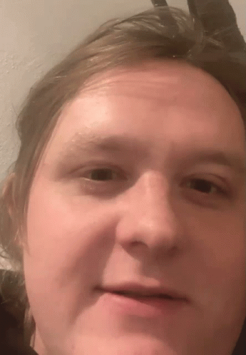 A Close Up Of A Man 'S Face With A Slight Smile GIF