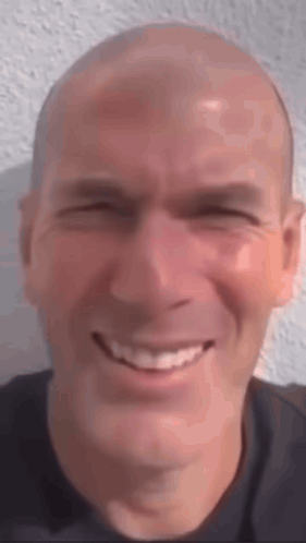 A Close Up Of A Man 'S Face With A Smile On His Face . GIF