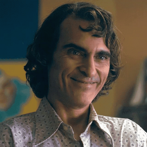A Close Up Of A Man 'S Face With A Smile On His Face GIF
