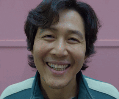 A Close Up Of A Man 'S Face With A Smile On His Face GIF