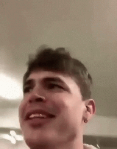 A Close Up Of A Man 'S Face With A Smile On It . GIF