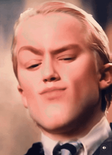 A Close Up Of A Man 'S Face With A Sound Button In The Lower Right Corner GIF