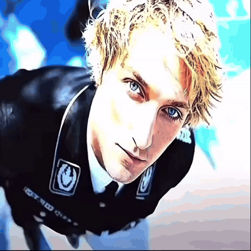 A Close Up Of A Man 'S Face With A Sticker On His Jacket That Says 100 GIF