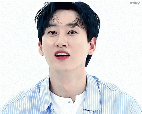 A Close Up Of A Man 'S Face With A Striped Shirt And A Pink Heart GIF