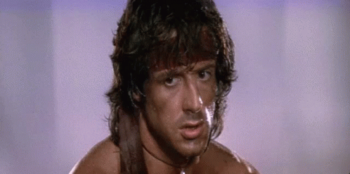 A Close Up Of A Man 'S Face With A Sword Around His Neck And A Choker . GIF