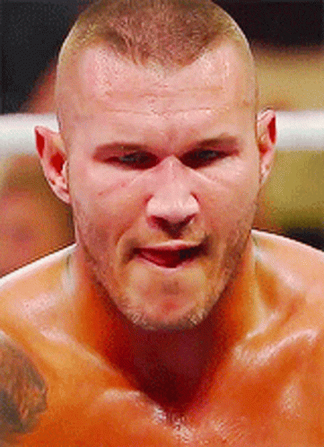 A Close Up Of A Man 'S Face With A Tattoo On His Chest GIF