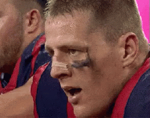 A Close Up Of A Man 'S Face With A Tattoo On His Nose GIF