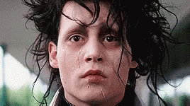 a close up of a man 's face with a tear coming out of his nose .