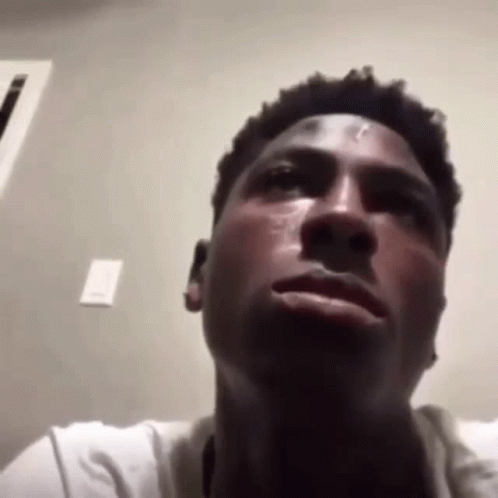 A Close Up Of A Man 'S Face With A Tear Running Down His Cheek . GIF