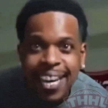 A Close Up Of A Man 'S Face With A Thhl Logo In The Background GIF