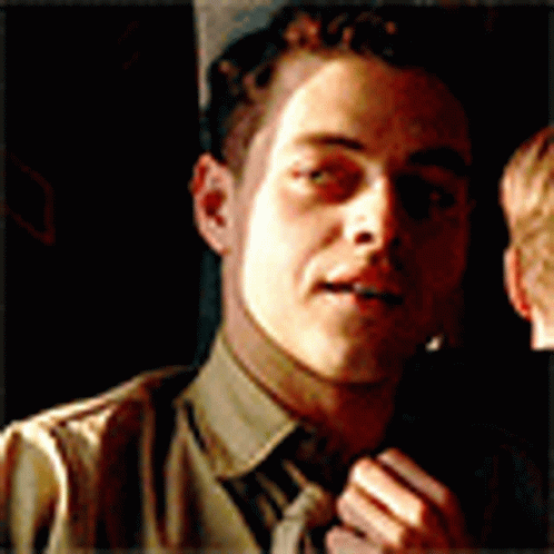 A Close Up Of A Man 'S Face With A Tie GIF