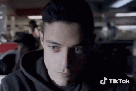 A Close Up Of A Man 'S Face With A Tiktok Logo In The Background GIF