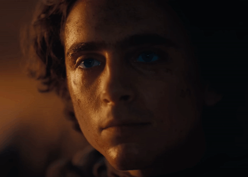 A Close Up Of A Man 'S Face With A Very Dark Background GIF