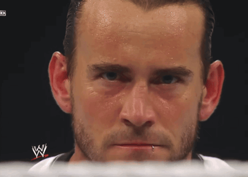 A Close Up Of A Man 'S Face With A W Logo On The Bottom GIF