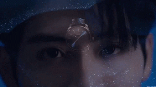 A Close Up Of A Man 'S Face With A Watch In The Foreground GIF