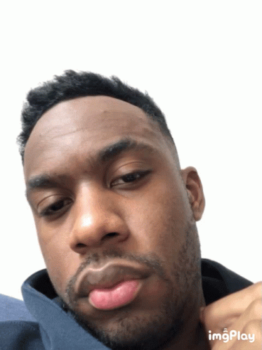 A Close Up Of A Man 'S Face With A White Background And The Word Imgplay At The Bottom GIF