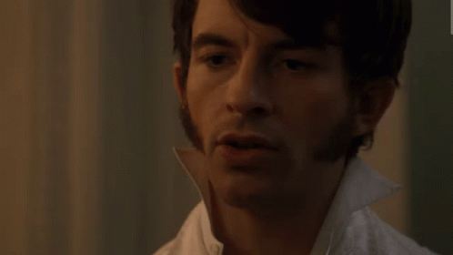 A Close Up Of A Man 'S Face With A White Collar GIF