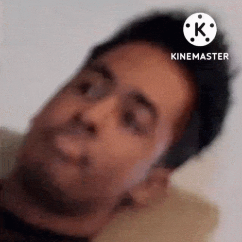 A Close Up Of A Man 'S Face With A White K On The Bottom GIF
