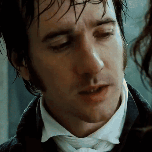 A Close Up Of A Man 'S Face With A White Shirt And Tie GIF
