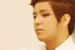 A Close Up Of A Man 'S Face With A White Shirt On And A Serious Look On His Face . GIF