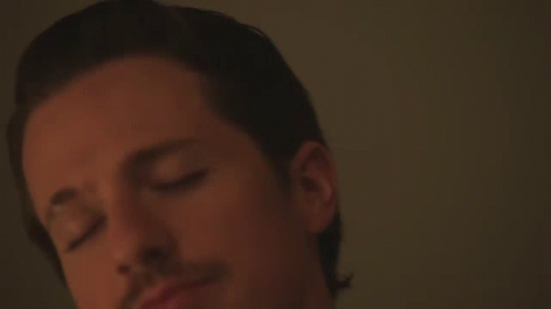 A Close Up Of A Man 'S Face With A White Shirt On GIF
