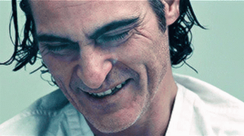 A Close Up Of A Man 'S Face With A White Shirt On GIF