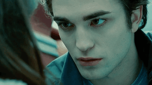 A Close Up Of A Man 'S Face With A Woman Looking At Him . GIF