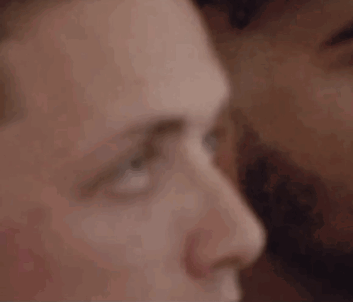 A Close Up Of A Man 'S Face With A Woman 'S Face Behind Him . GIF
