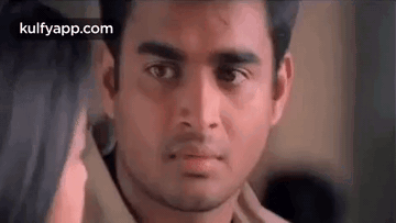 A Close Up Of A Man 'S Face With A Woman 'S Hand On His Shoulder . GIF