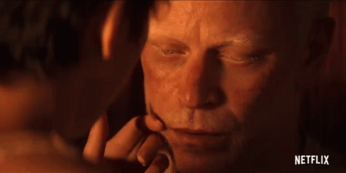 A Close Up Of A Man 'S Face With A Woman 'S Hand Touching It . GIF