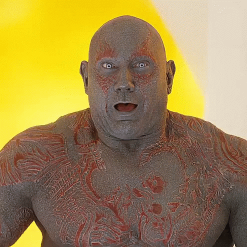 A Close Up Of A Man 'S Face With A Yellow Background GIF
