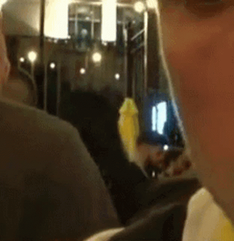 A Close Up Of A Man 'S Face With A Yellow Object In His Mouth GIF
