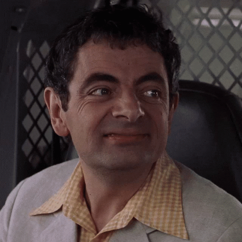 A Close Up Of A Man 'S Face With A Yellow Shirt On GIF