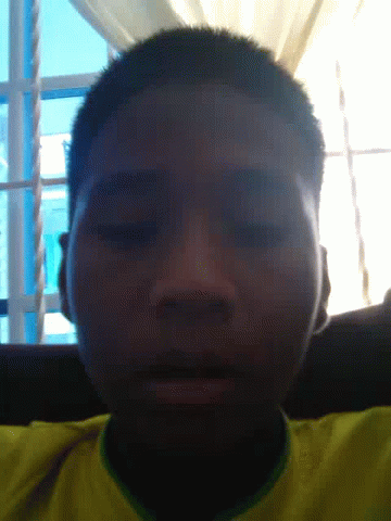 A Close Up Of A Man 'S Face With A Yellow Shirt GIF