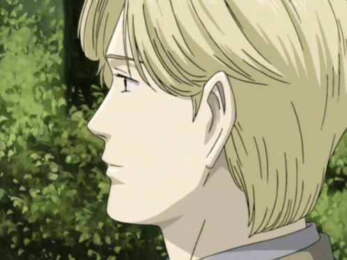 A Close Up Of A Man 'S Face With Blonde Hair And A Green Background GIF