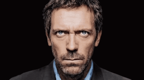 A Close Up Of A Man 'S Face With Blue Eyes GIF