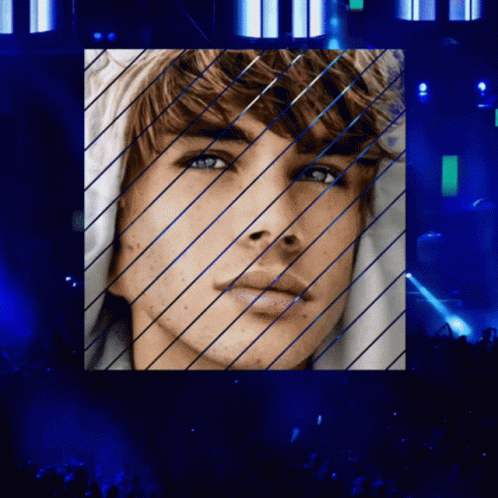 A Close Up Of A Man 'S Face With Blue Lines GIF