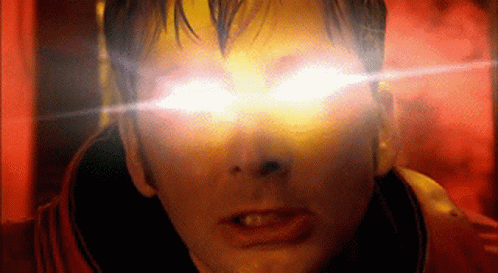 A Close Up Of A Man 'S Face With Bright Yellow Eyes GIF