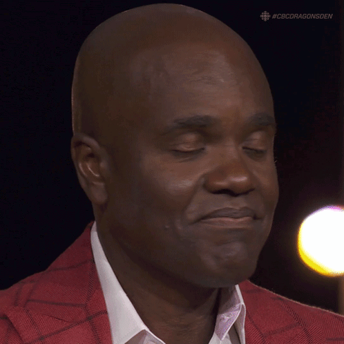 A Close Up Of A Man 'S Face With #Cbcdragonsden On The Bottom GIF